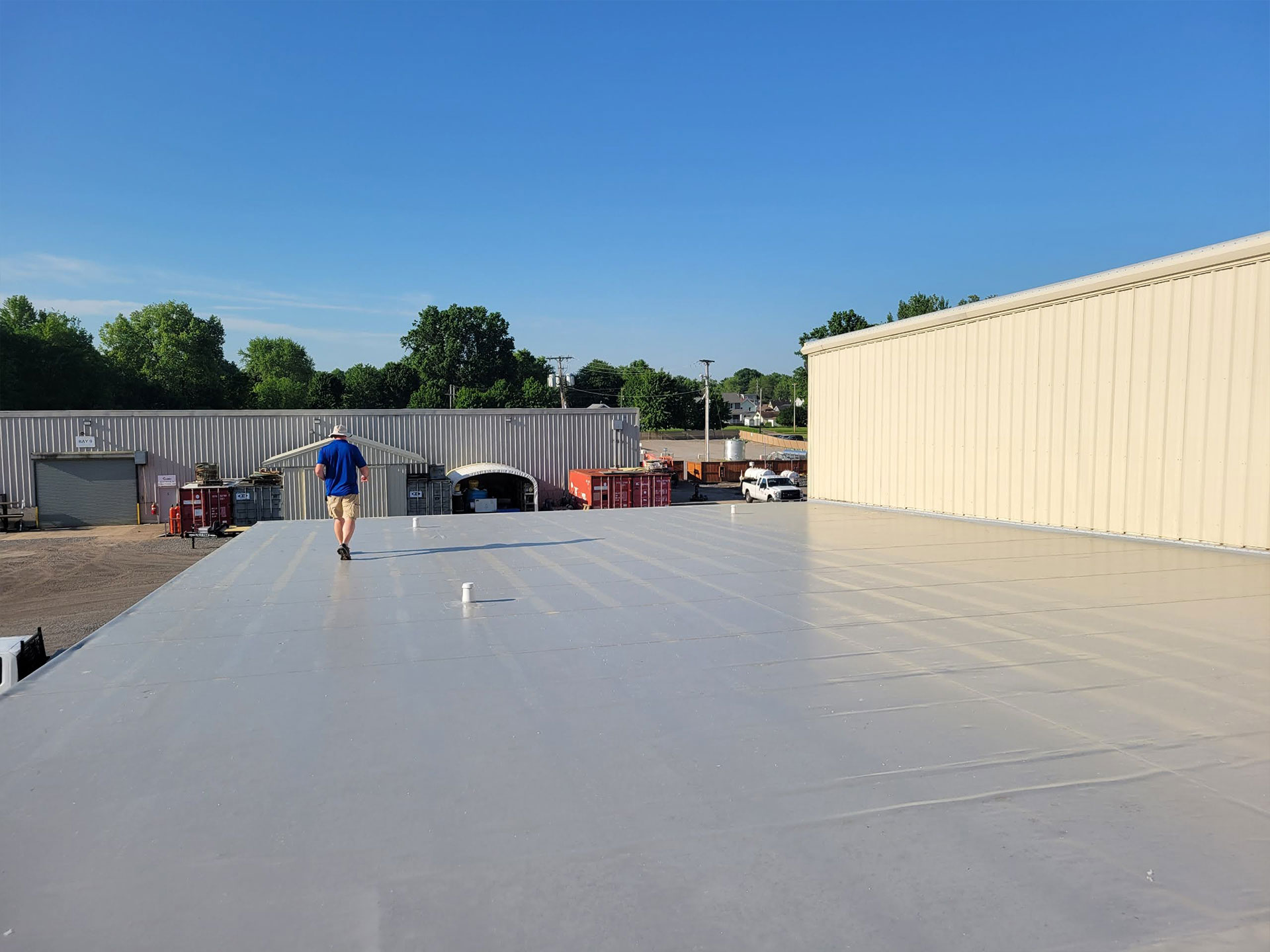 roofer walking across a commercial roof