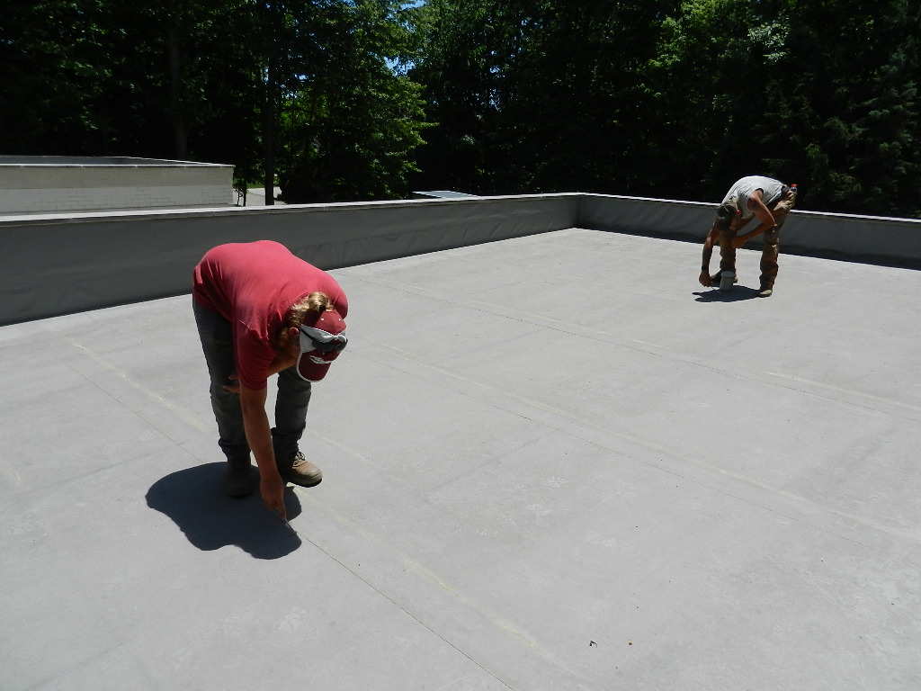 two men performing a commercial roof inspection