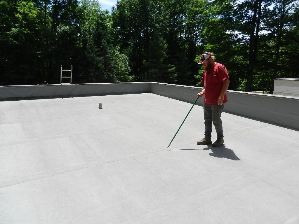 man performing a commercial roof inspection